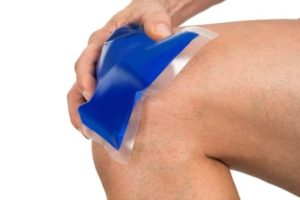 36193086 - close-up of hand holding ice gel pack on painful knee